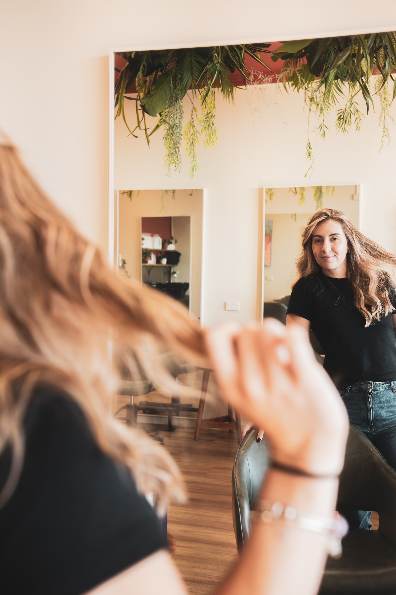 Finished hair being viewed in the salon mirror