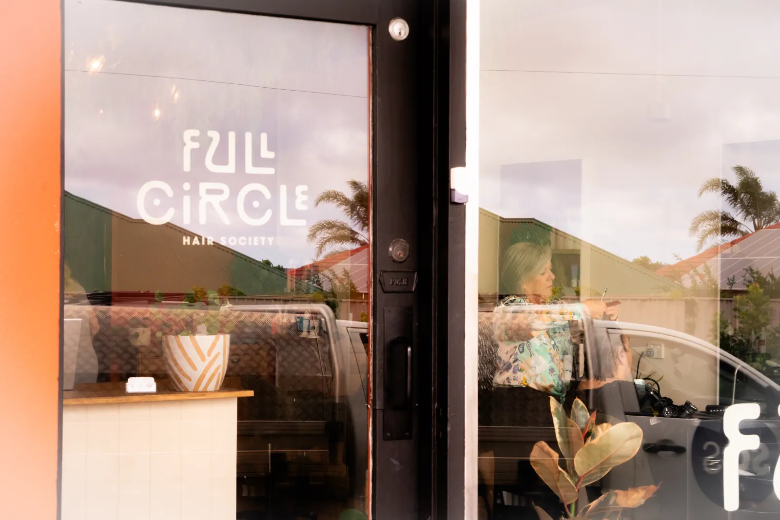 Full Circle Hair Society seen through the salon entrance